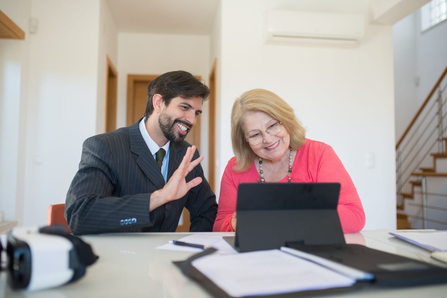 An adviser going through figures on a tablet with a client
